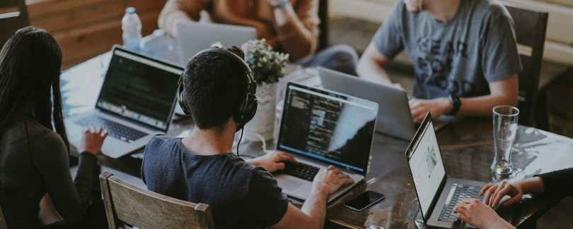 group of people using laptop computer