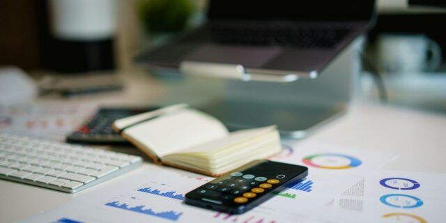 office desk with smartphone and financial charts